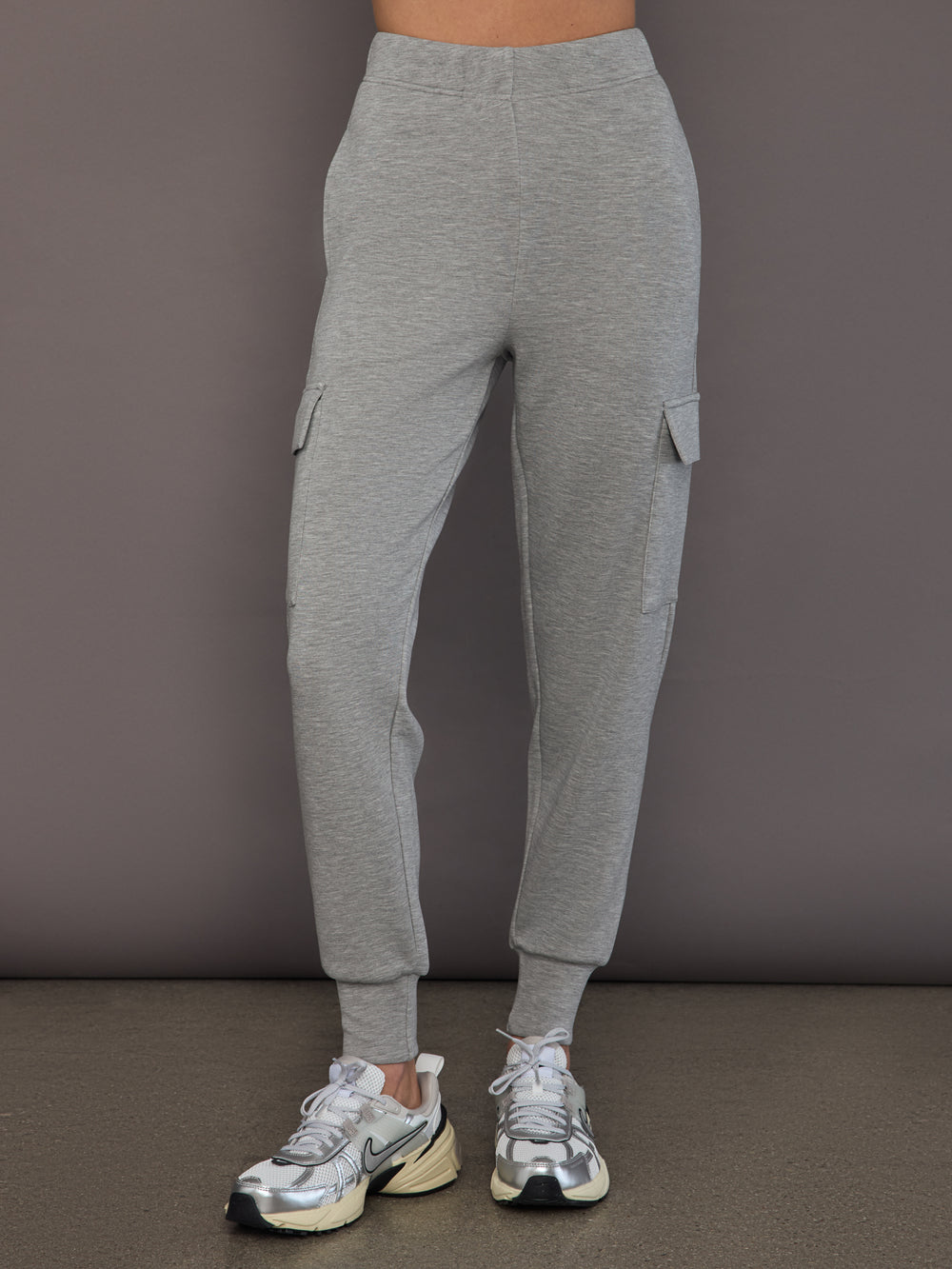Model is wearing a heather grey Ultrasoft Cargo Jogger with flap pocket detail and tapered leg, front view.