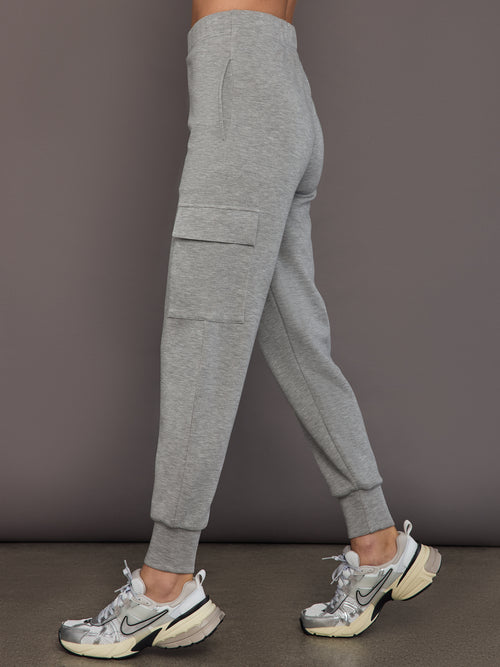 Model is wearing a heather grey Ultrasoft Cargo Jogger with flap pocket detail and tapered leg, side view.