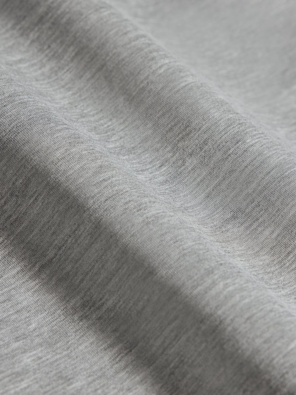 Close-up of heather grey ultrasoft fabric showing smooth texture and lightweight finish.