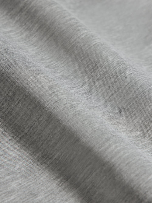 Close-up of heather grey ultrasoft fabric showing smooth texture and lightweight finish.