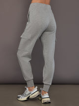 Model is wearing heather grey Ultrasoft Cargo Jogger with flap pocket detail and tapered leg, back view.