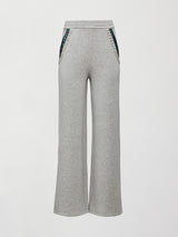 Front flat lay of grey wide-leg embellished pants with jeweled pockets on white background.