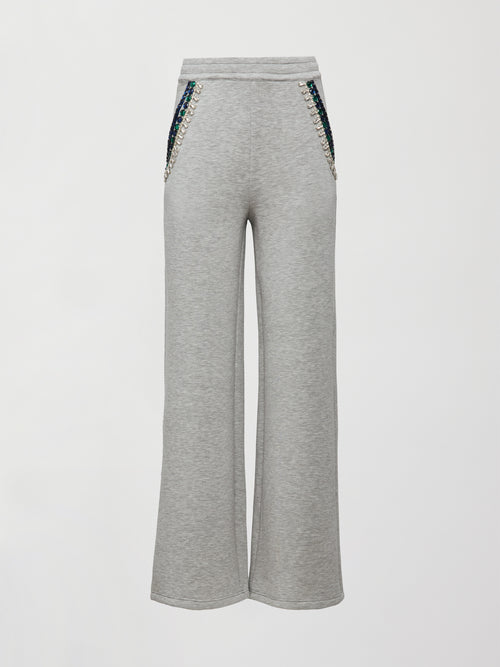 Front flat lay of grey wide-leg embellished pants with jeweled pockets on white background.