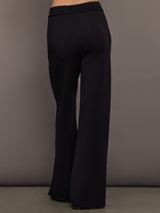 Back view of black wide-leg pants with relaxed fit and clean hem.