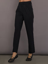 Model is wearing the scuba tuxedo pant in black, front view.