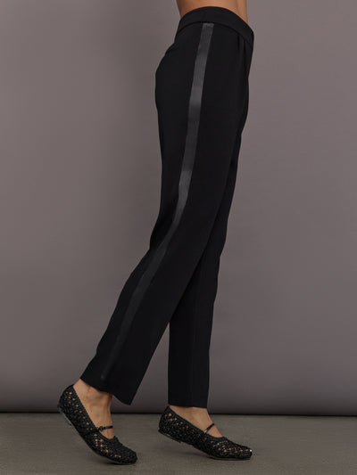 Model is wearing the scuba tuxedo pant in black, side view.