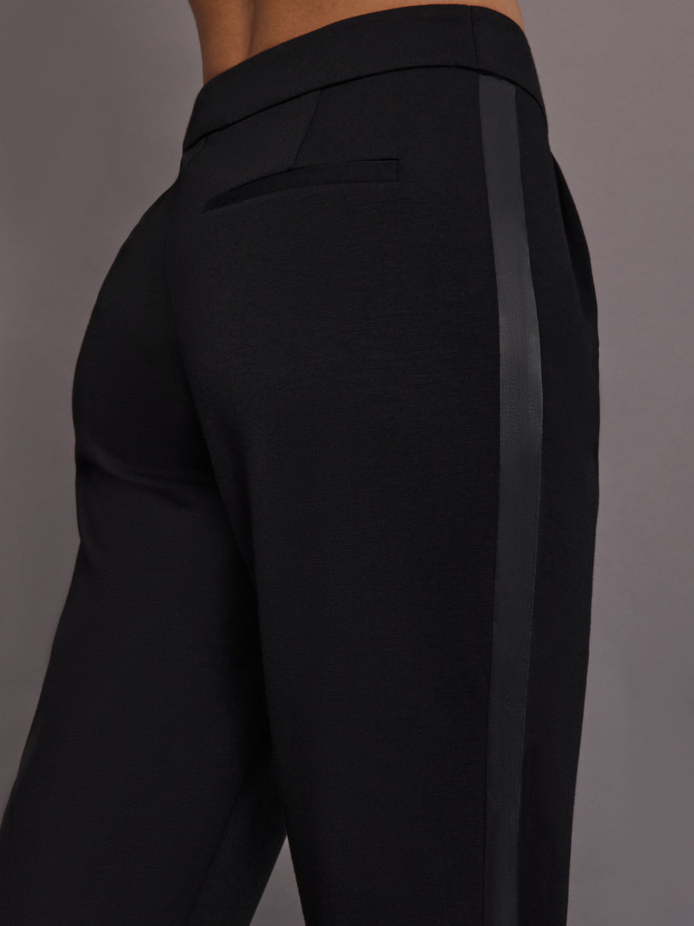 Close up of scuba tuxedo pant in black showing satin stripe.