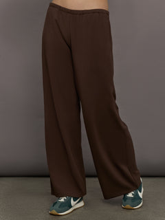 Model is wearing Scuba Mid Rise Pull On Pant in Carafe, front view.