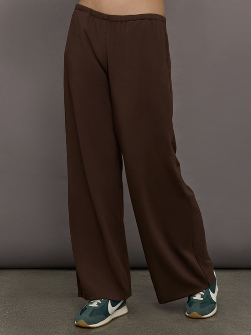 Model is wearing Scuba Mid Rise Pull On Pant in Carafe, front view.