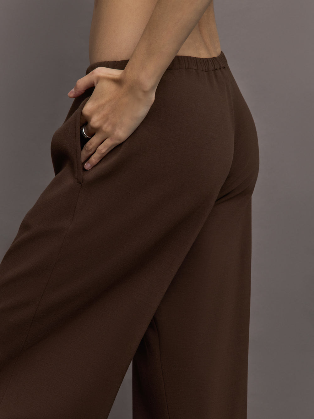 Model is wearing Scuba Mid Rise Pull On Pant in Carafe, close up of side pocket detail.