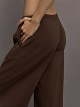 Model is wearing Scuba Mid Rise Pull On Pant in Carafe, close up of side pocket detail.