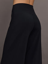 Model is wearing Pleated Palazzo Pant in Melt Black, close-up fit and drape detail.