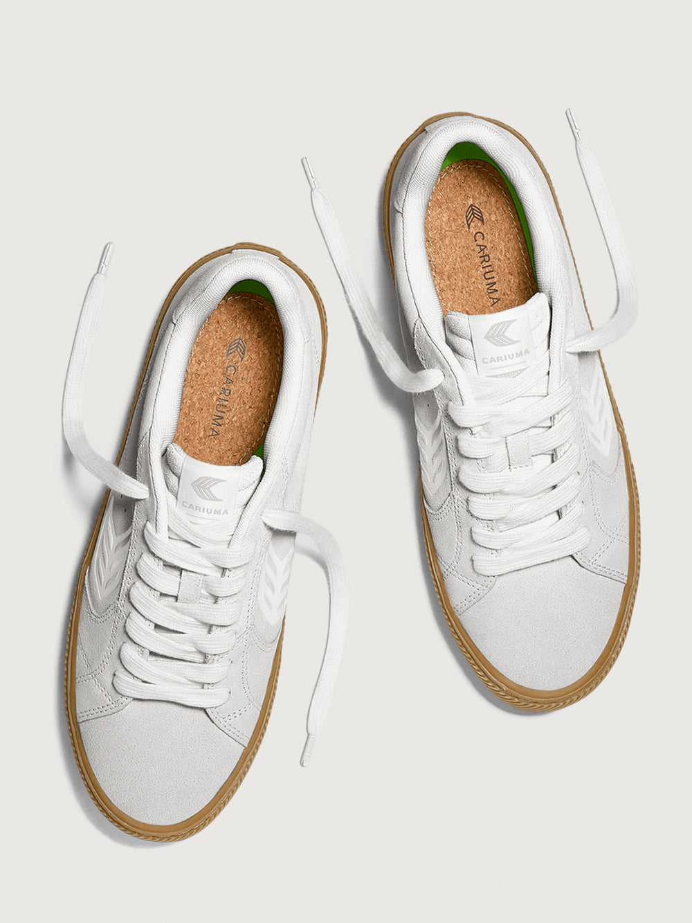 Suede white/light gray sneaker with light brown sole. 