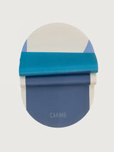 Navy Aeris yoga mat in Navy and Blue shown folded to highlight flexibility and bold colorblock pattern.