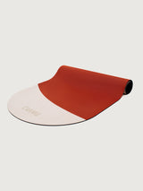 Angled view of Balance yoga mat in Pink and Dark Red colorblock design partially unrolled with CARMU branding.
