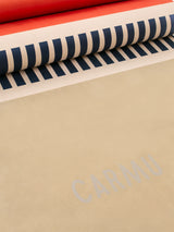 Close-up of Groove yoga mat in Orange Geo Print showing striped pattern, textured grip, and CARMU branding.