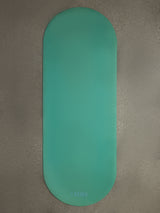 Teal Gradient yoga mat displayed flat on textured concrete surface with CARMU logo visible.