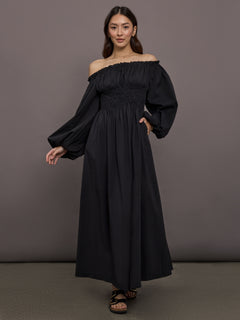 Model is wearing the Raquela off the shoulder ruffle maxi dress in black, full body front view.