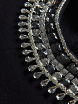 Close-up of black jewel embellished sweatshirt showing crystal beading and textured detail.