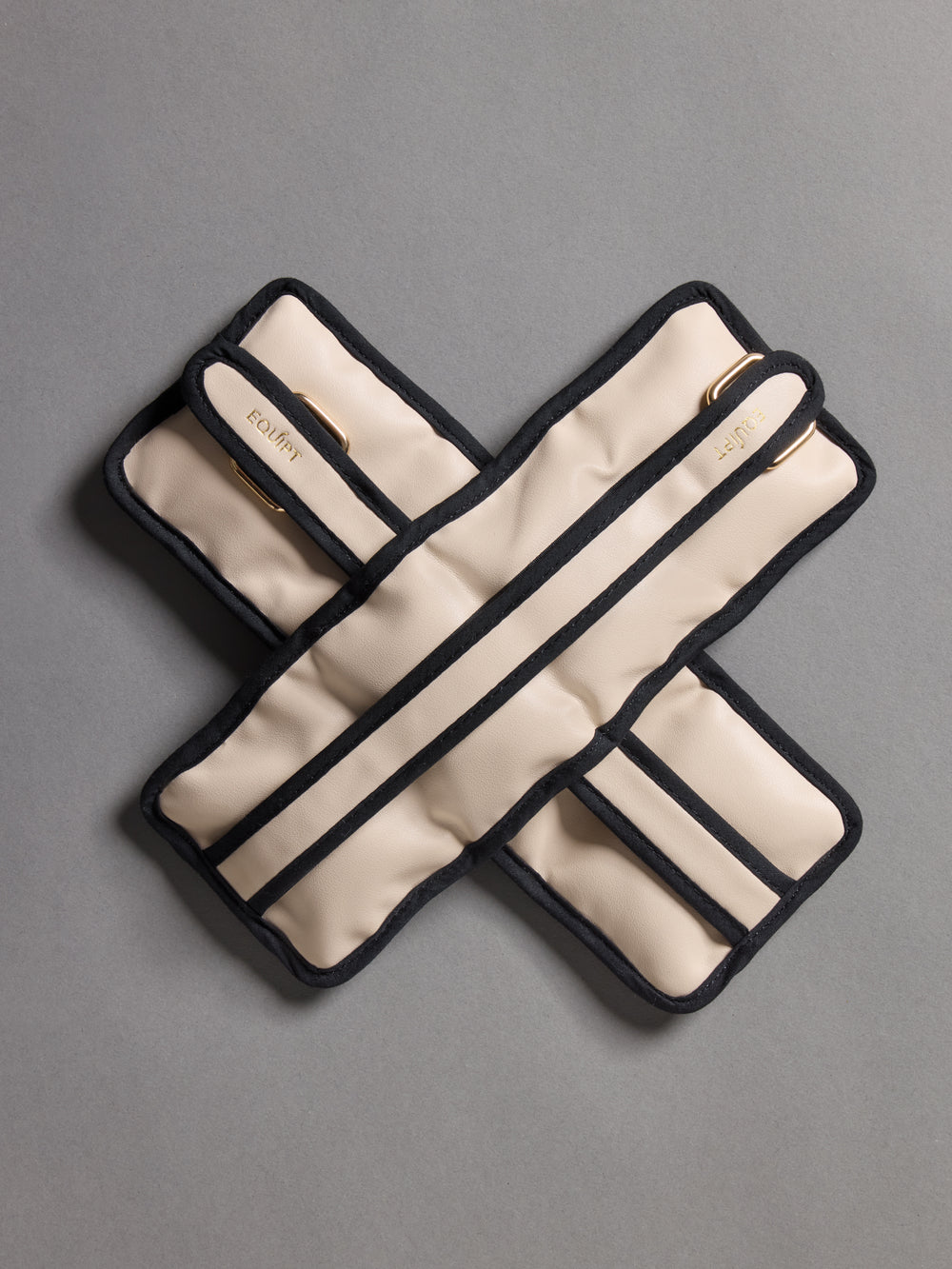 Flat lay of the Vegan Leather Weighted UWrap 1.5 Classic Ivory, crossed strap detail.