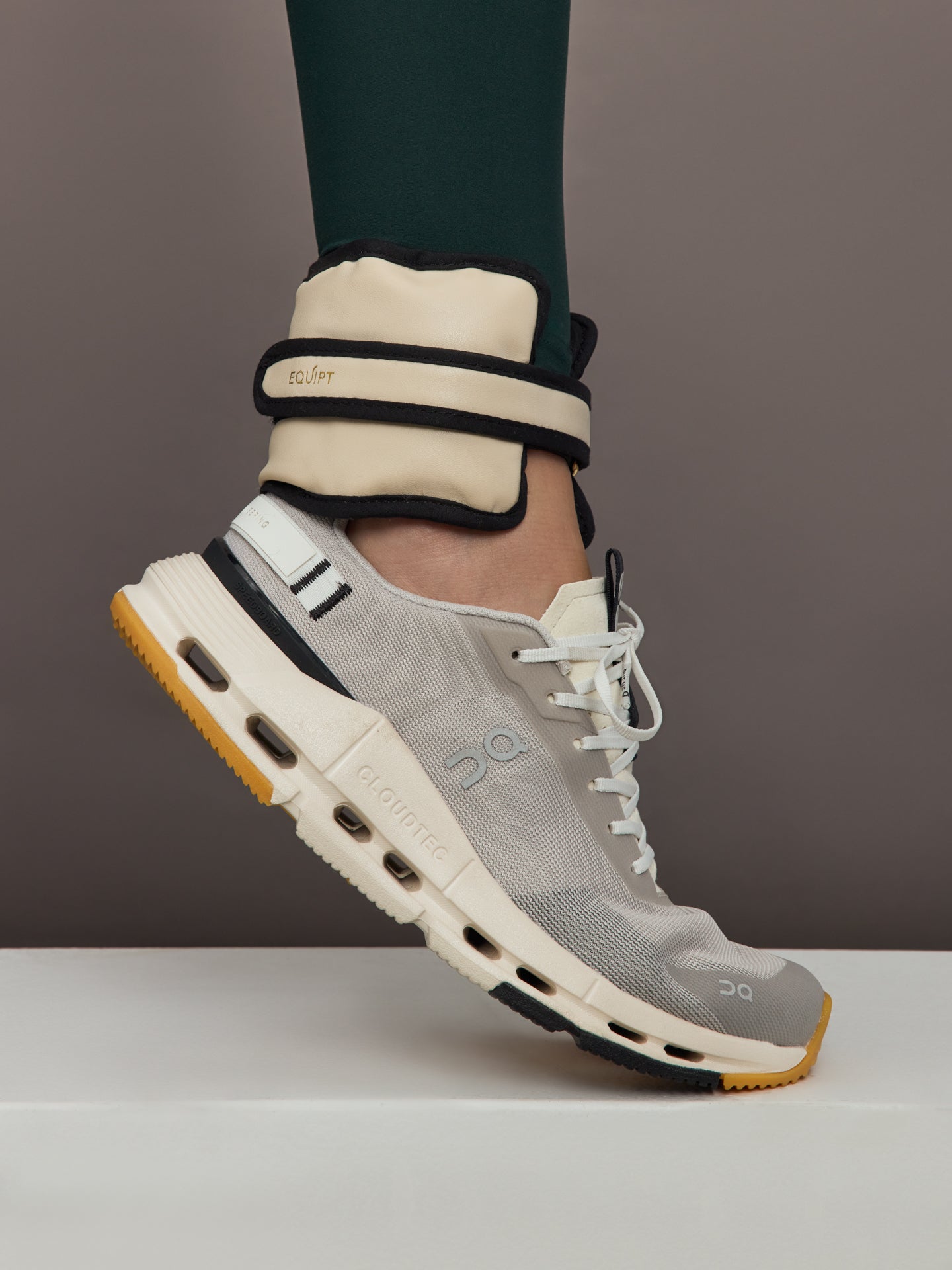 Model is wearing the Vegan Leather Weighted UWrap 1.5 Classic Ivory, ankle view during movement.