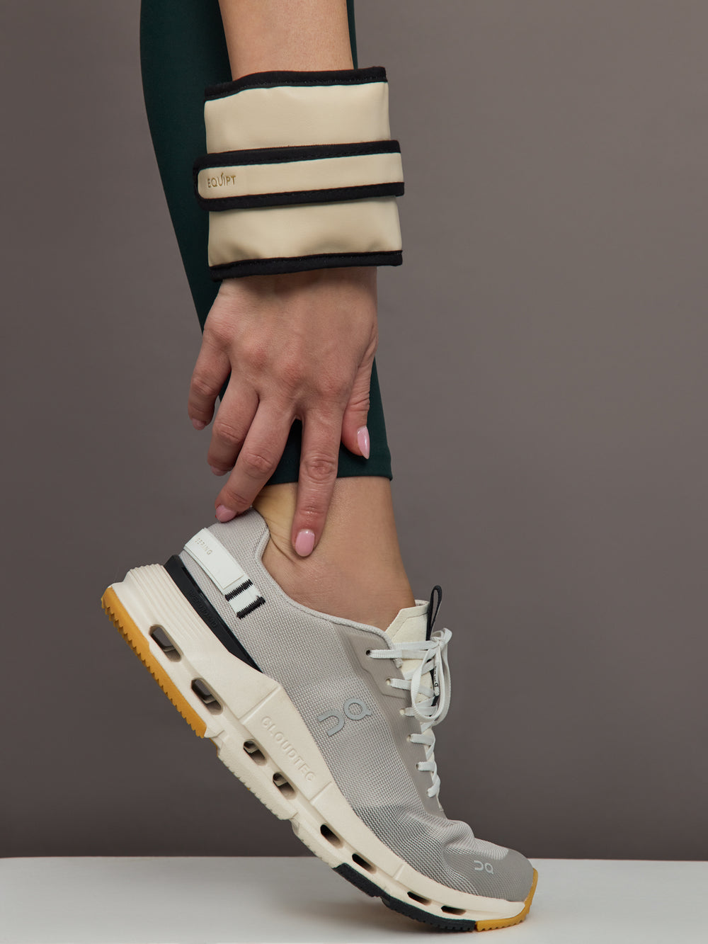 Model is wearing the Vegan Leather Weighted UWrap 1.5 Classic Ivory, wrist view.