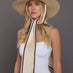 Front view of model wearing natural vented hemp fedora with ivory scarf tie.
