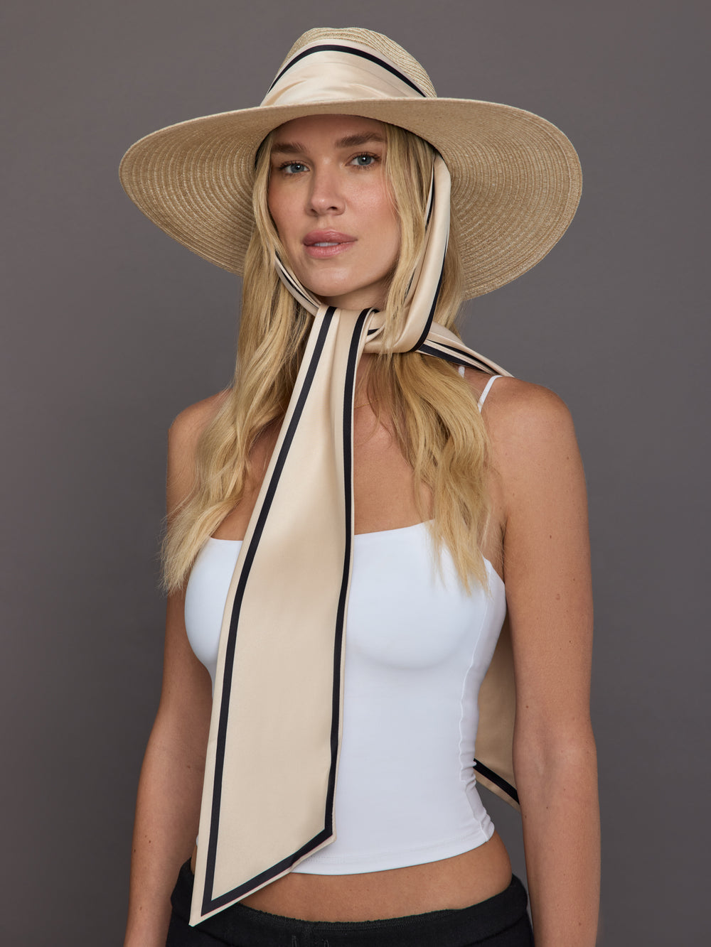 Front view of model wearing natural vented hemp fedora with ivory scarf tie.