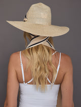 Back view of wide-brim hemp fedora showing ivory scarf draped over shoulders.