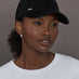 Model wearing black baseball cap