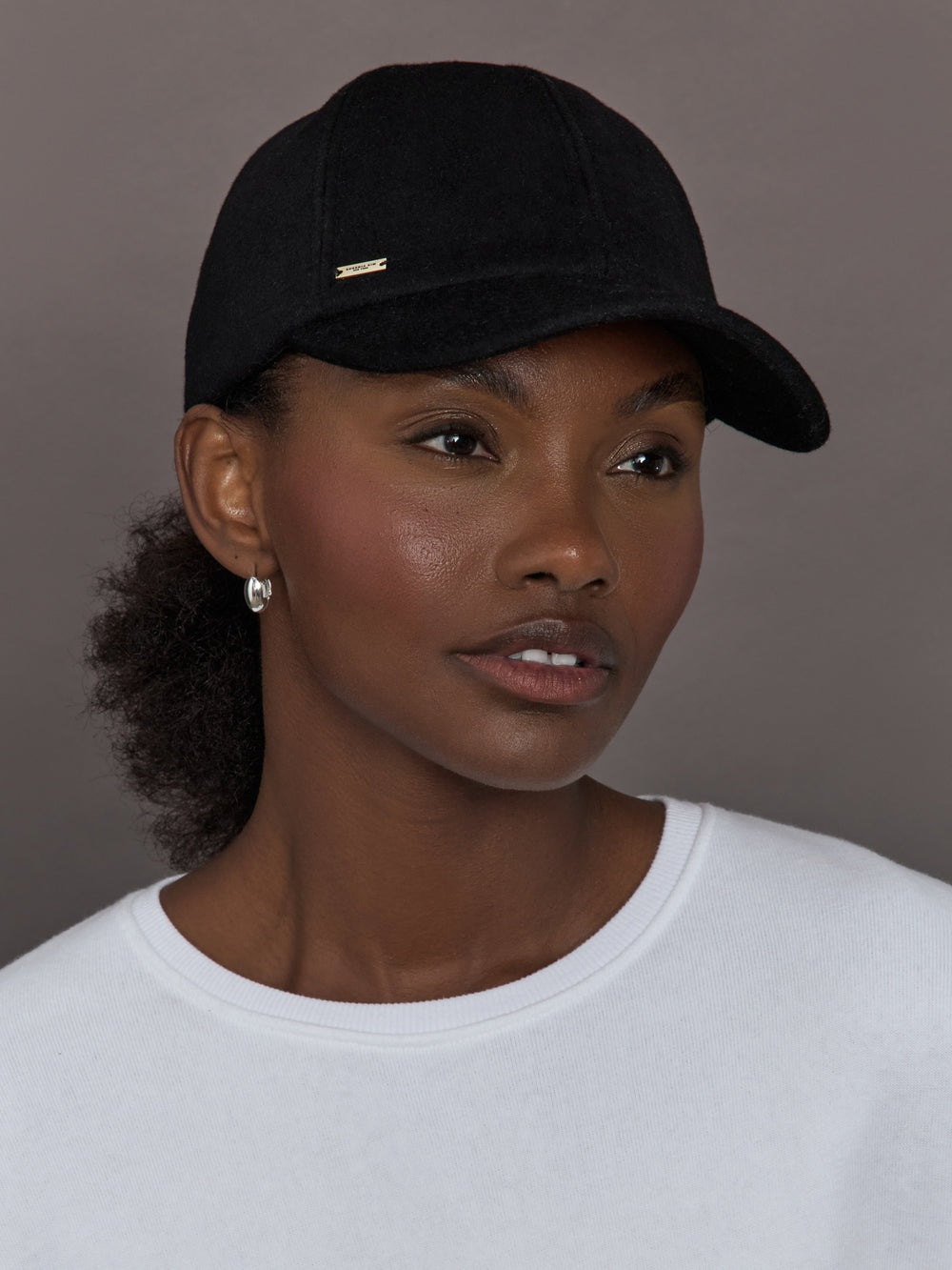 Model wearing black baseball cap