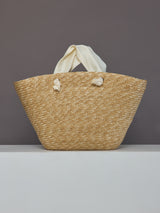Back view of straw tote bag with ivory satin handles and no bow.