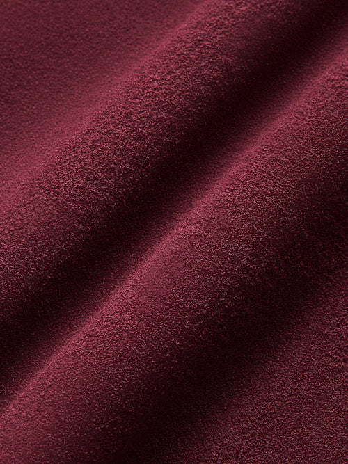 Model wearing a Fig colored long-sleeve top with knot detail