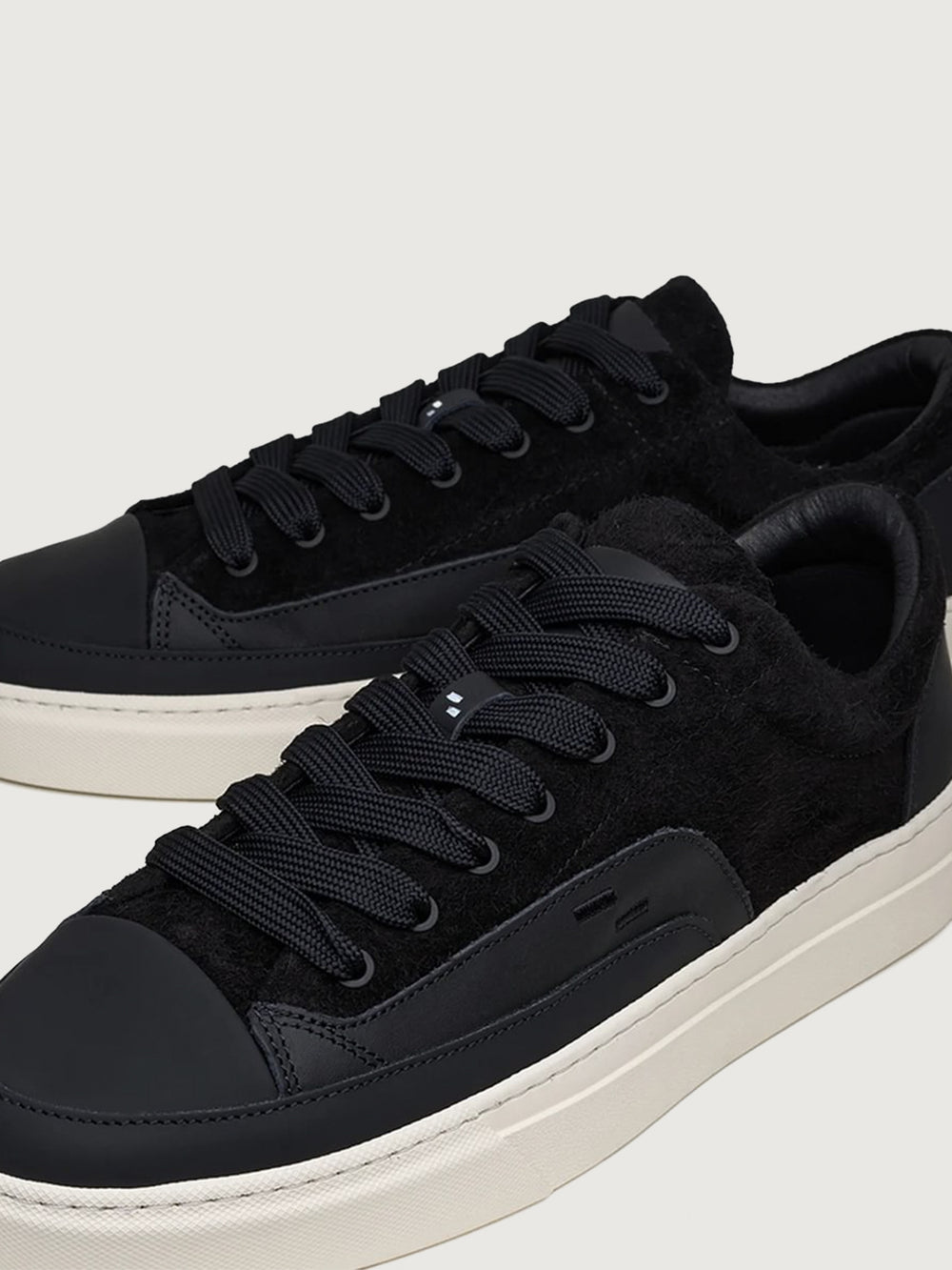 Close-up of Filling Pieces Riviera Fuzz sneaker in black with textured suede panels, leather accents, and thick contrast laces.