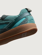 Close-up of Filling Pieces Prism Peak sneaker in green with perforated leather heel, embossed logo on gum sole, and textured outsole.