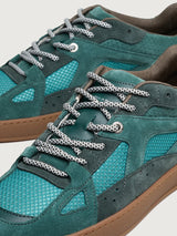Close-up of Filling Pieces Prism Peak sneaker in green with textured mesh panels, suede overlays, and contrast laces.
