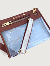 Clear vinyl pouch with brown leather trim, gold zipper, and detachable logo strap.