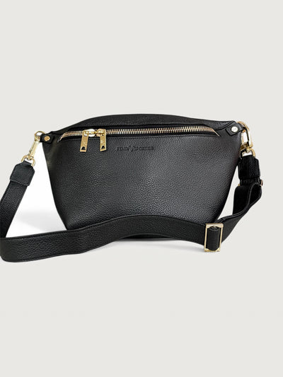 Black pebbled leather handbag that can also be worn as a crossbody with gold hardware and double zippers. 