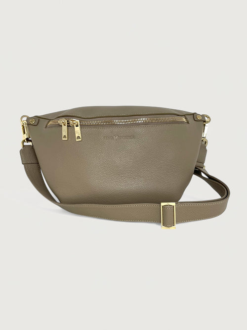 Beige/taupe pebbled leather handbag that can also be worn as a crossbody with gold hardware and double zippers. 