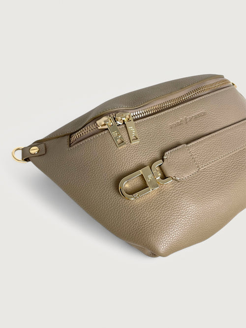 Beige/taupe pebbled leather handbag that can also be worn as a crossbody with gold hardware and double zippers. 