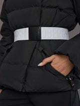 Close up of the Bufera Ski Jacket in black, white belt detail and zippered pocket in frame.
