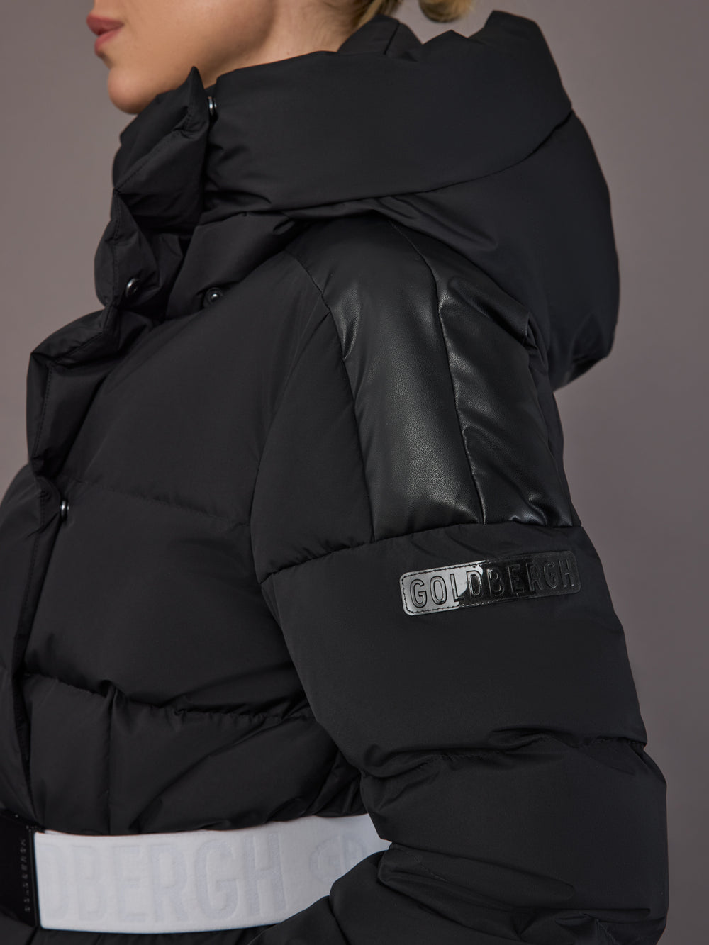 Close up of the Bufera Ski Jacket in black, showing the sleeve logo and matte texture.