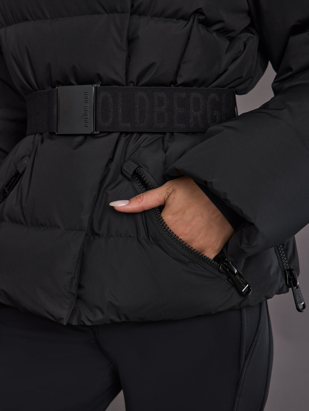Close up of the Bufera Ski Jacket in black, black belt detail and matte shell texture.