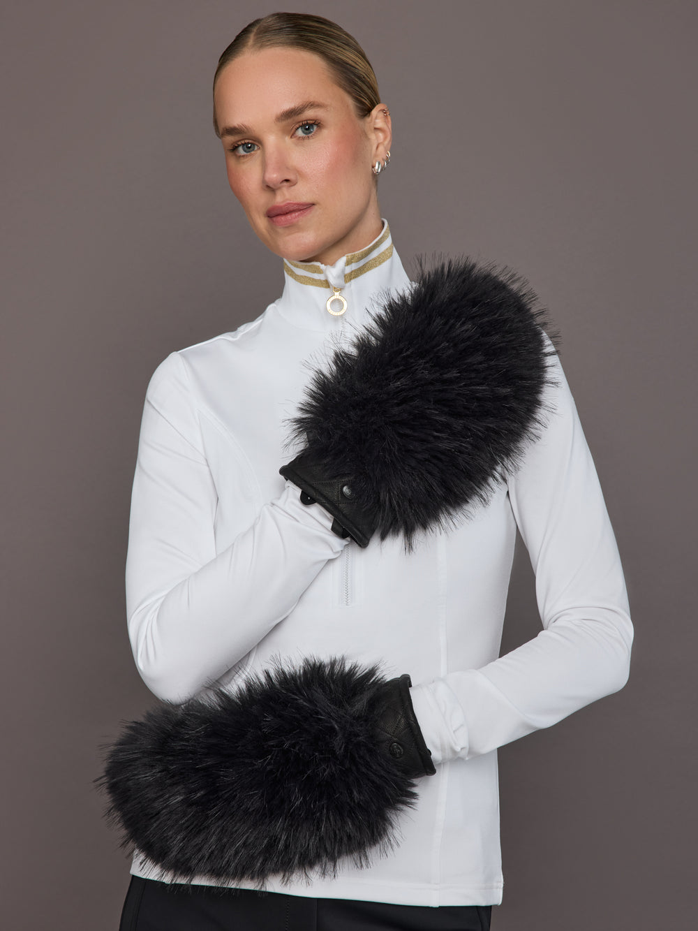 Black leather faux fur mittens on model, front arm view.