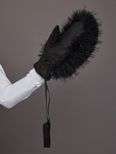 Black leather faux fur mitten on model, side view with wrist strap detail.