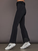 Black softshell ski pant on model, side view showing straight leg fit.