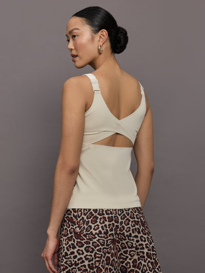 Model wears a neutral colored tank top. 
