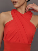 Model wears a cross front cinched waist red mini dress.