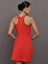 Model wears a cross front cinched waist red mini dress.