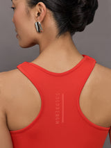 Model wears a cross front cinched waist red mini dress.